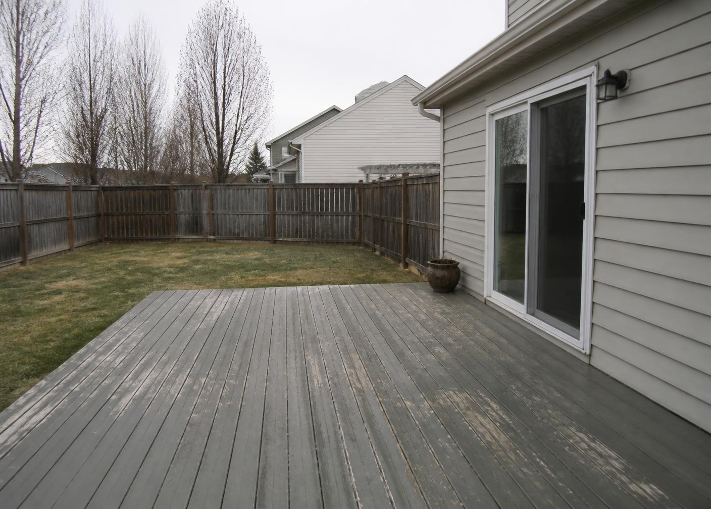 Weathered deck and unused backyard before improvement