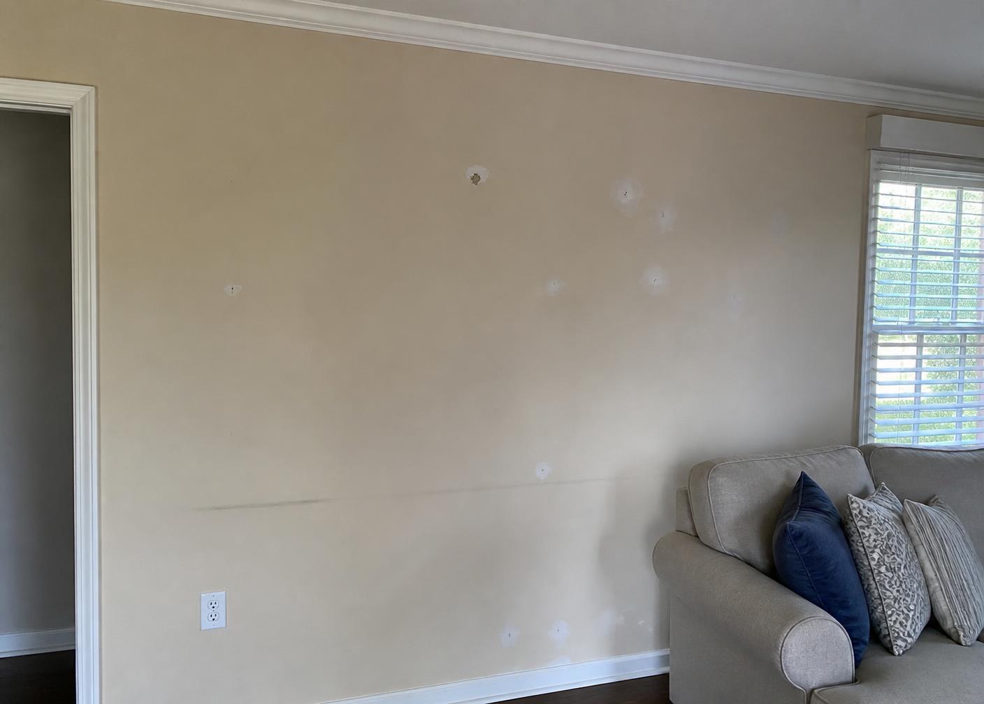 Interior wall with faded paint and visible patches